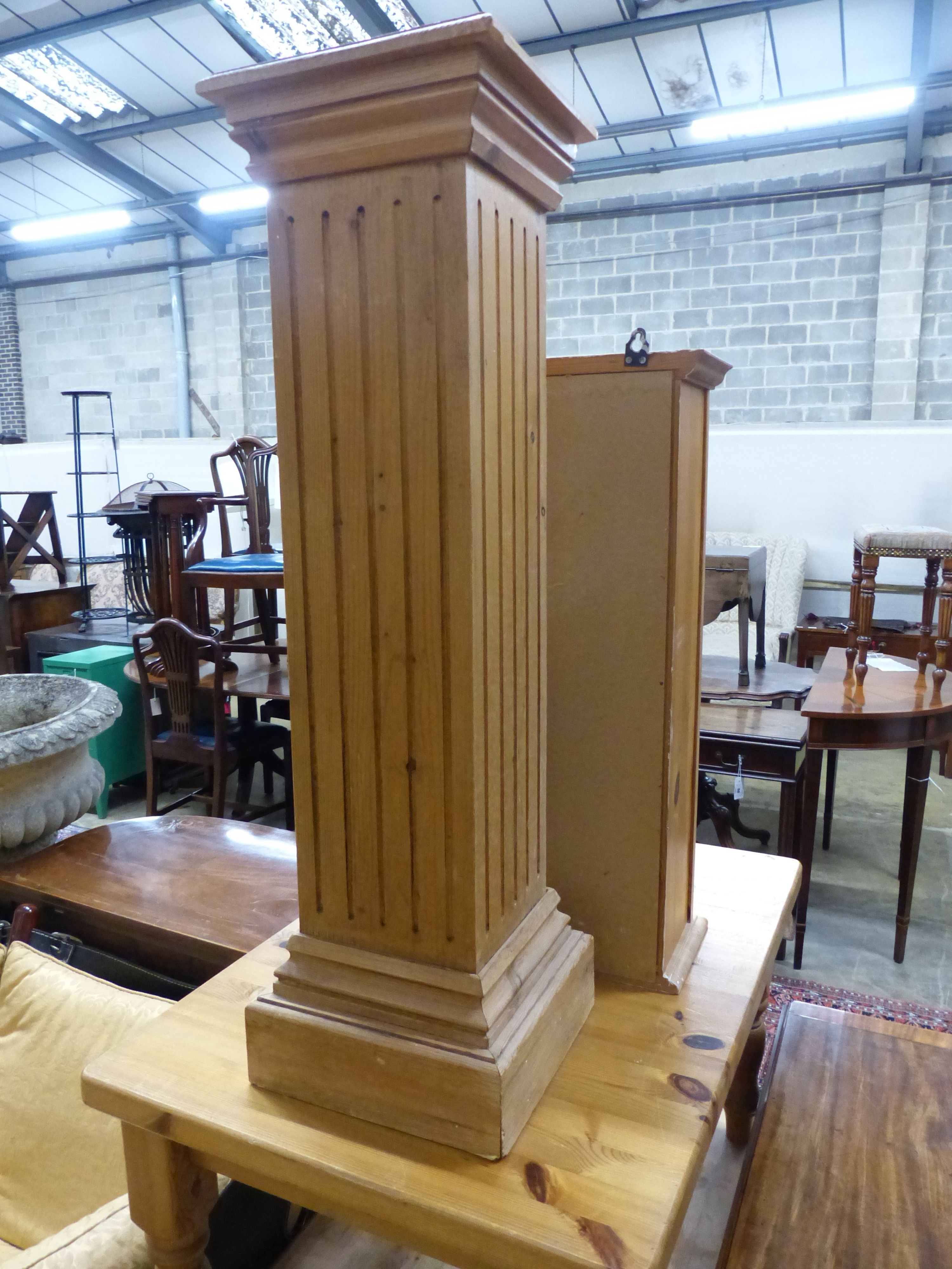 Two rectangular pine coffee tables, a pedestal and a wall cabinet